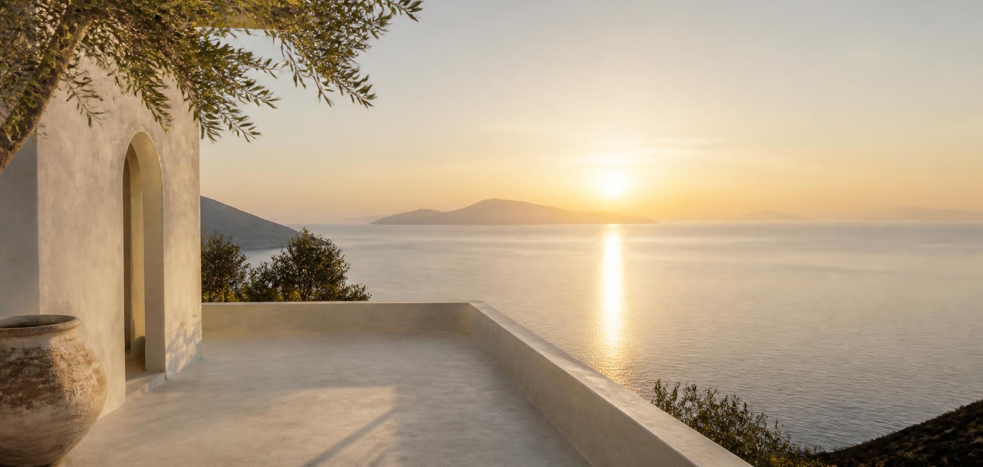 Mediterranean sunrise over a calm sea seen from a stone terrace